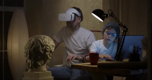 Man with VR Headset and Child using Computer