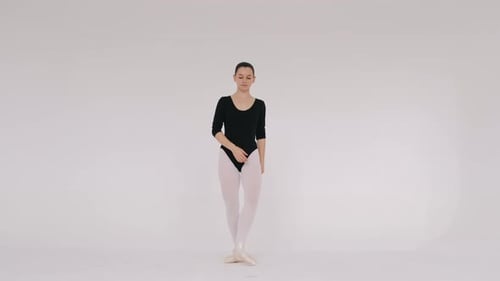 Woman Dancing Gracefully in Ballet Studio