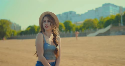 Pretty Young Woman Walking on the Beach