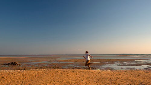 Excited Man Running on Beach