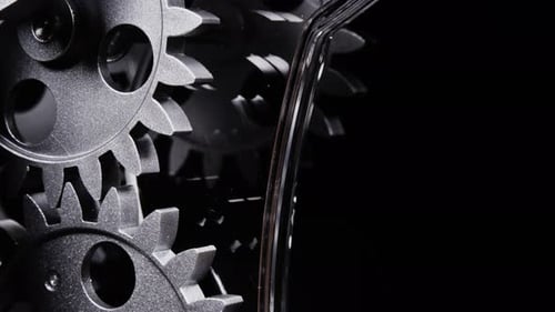 Metal Gears Turning on a Black Background