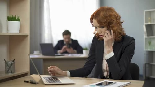 Businesswoman Talking on Phone in Modern Office