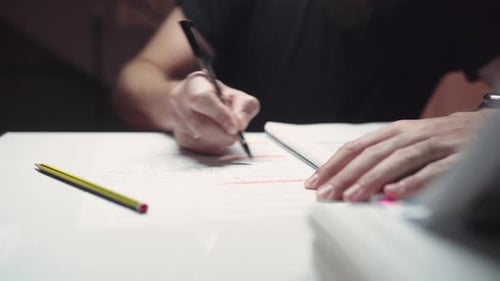 Man Studying And Underlining Important Text On The Reviewer Using Ballpen. - close up