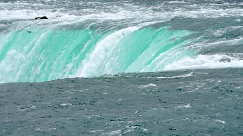 Close-up View of the Powerful Raging Whitewater Waterfall Falling Forcefully Over a Rocky Edge