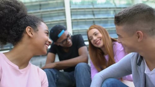 Smiling Young Adults Talking Together in an Urban Setting