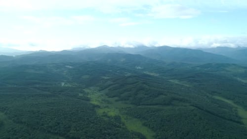 Aerial Drone View Beautiful Natural Scenery of Green Hills with Mountains in Background