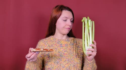 Woman Choosing Between Pizza and Celery