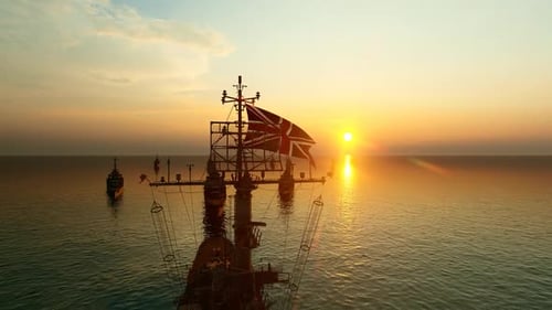 British Naval Fleet with Union Jack Flag Sailing at Sunset