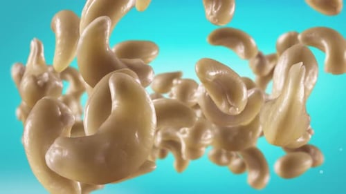 Cashews Falling in a Sphere on Turquoise Background