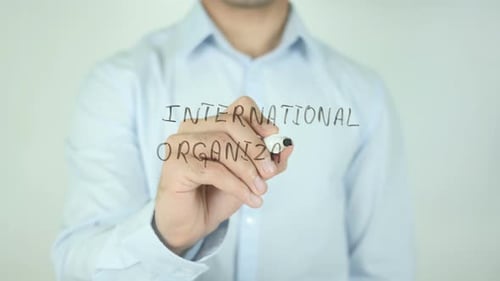 Writing International Organization with Marker Close Up