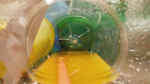 Plastic Bottle Filled with Liquid, Surrounded by Waste