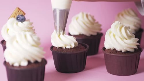 Decorating Chocolate Cupcakes with White Creamy Icing