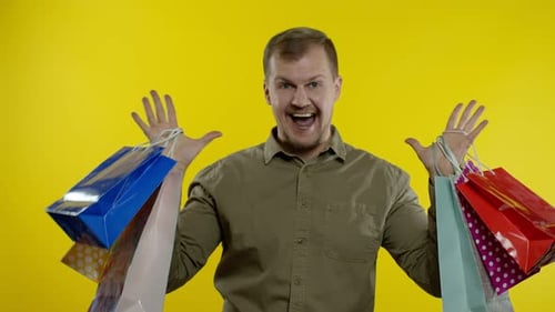 Happy Man Holding Shopping Bags Smiling