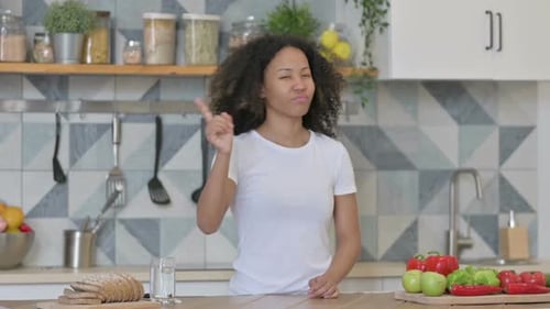 Young African Woman Shaking Head As No Sign While in Kitchen
