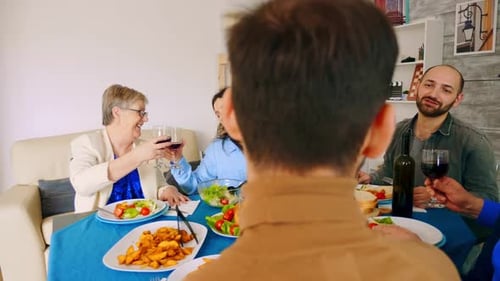 Festive Family Meal with Wine and Laughter Indoors