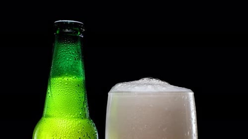 Close-up of Beer Bottle and Glass with Foam