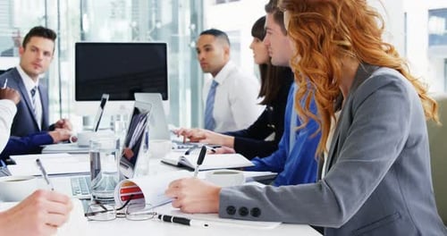 Professionals Collaborate During Meeting in Modern Office