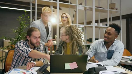 Excited Team Celebrates Success in Modern Office