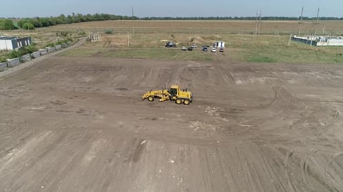 Heavy Machinery at Work in the Field on a Sunny Day Aerial Shot
