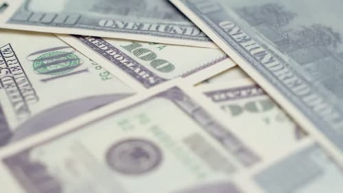 Hundred Dollar Bills Spinning on a Table Top View
