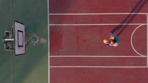 Aerial View. Man Playing Basketball on the Court.