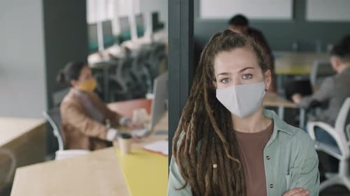 Portrait of Woman in Face Mask Posing in Office