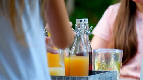 Kids Opening Juices at a Birthday Snack Table