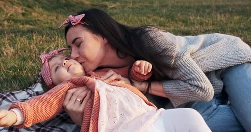 Mother and a Small Daughter, Spends Time Together in a City Park on a Picnic, Young Woman and Little