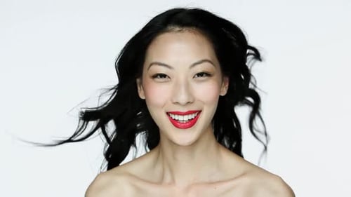 Smiling Woman with Flowing Hair and Red Lipstick