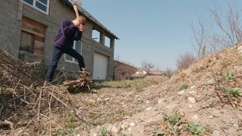 Man In The Backyard Chopping Wood Slow Motion