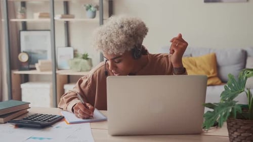 Black Woman Call Center Agent Wear Headset Work on Laptop Consult Client Online