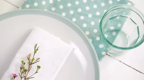Clean Table Setting with Plate, Napkin and Flowers