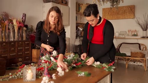 Women Crafting Christmas Decoration at a Wood Table