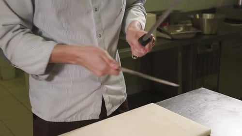 Chef Sharpening Knife with Steel in Kitchen