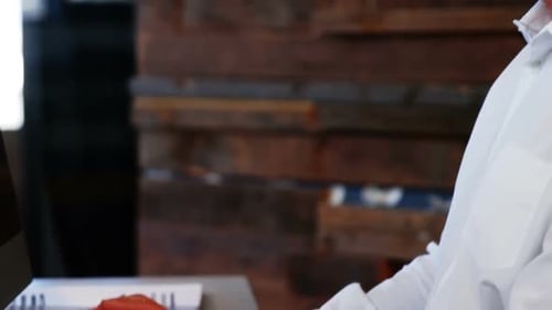 Man Typing on Computer Keyboard in Modern Office