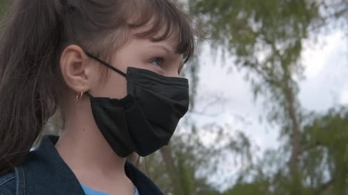 Child Wearing Protective Face Mask Outdoors