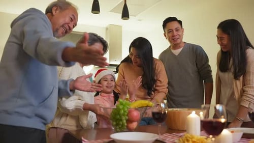 Family Celebrates Holiday Together at Home at Night