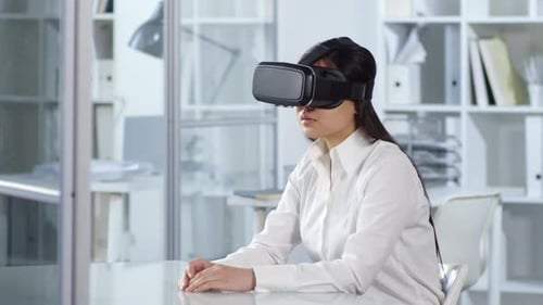 Asian Woman Using VR Headset in Office
