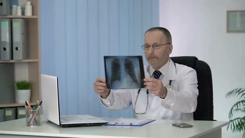 Doctor Examines Chest X-Ray in Office