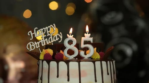 Birthday Cake with Candles Being Extinguished