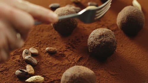 Closeup Confectioner Hand Cutting Truffle Chocolate By Fork in Slow Motion.