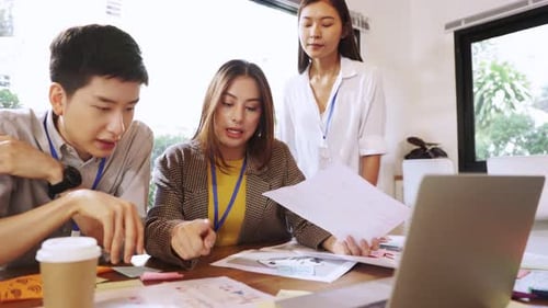 Young people with face masks back at work in office after lockdown.Asian