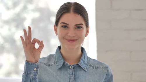 Young Woman Gives OK Hand Gesture