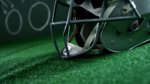 Football Helmet Resting on Turf Close Up