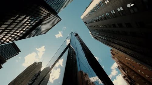 Bottom View of Pass By Several Skyscrapers in a Peaceful City Under the Cloudy Sky in Calm Day