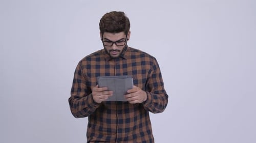 Man Using Tablet Device, Smiling