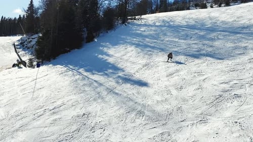 Skier Skiing Downhill in Winter Resort Mountains