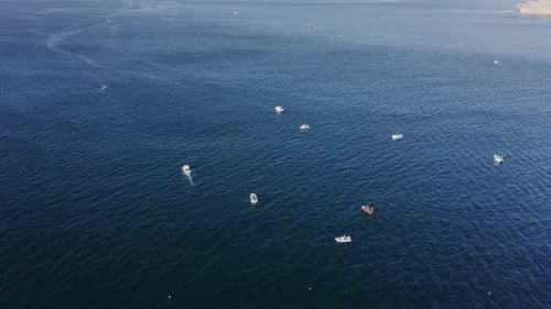 Sailing Boats During Fishing Along Flat Waters of the Sea Seen From Top
