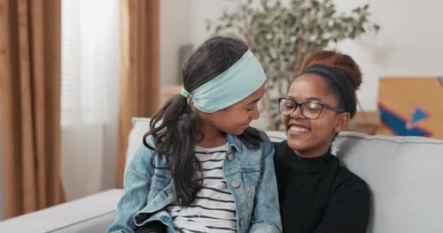 Happy Child with Young Adult Smiling on Couch