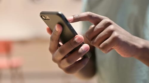 Close Up of African Man Using Smartphone